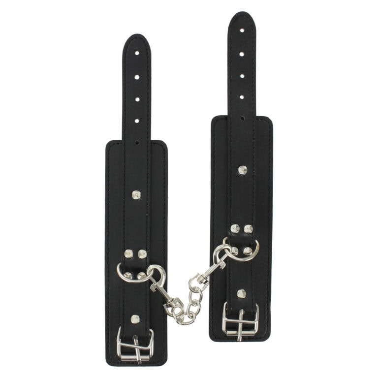 Adjustable leather bondage cuffs with metal chain for BDSM restraint, enhancing intimacy and trust in adult play. Perfect for couples exploring kink and fetish activities.