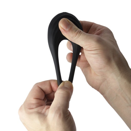 A person's hand holding a black plastic object.