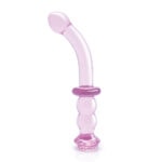 A pink glass sex toy on a white background.