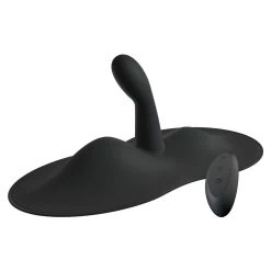 A black sex toy sitting on top of a white surface.