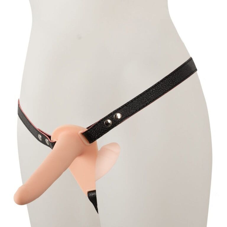 An image of a realistic dildo attached to a black strap harness, designed for adult intimacy and pleasure enhancement. Perfect for exploring different sensations and adding excitement to intimate mome.