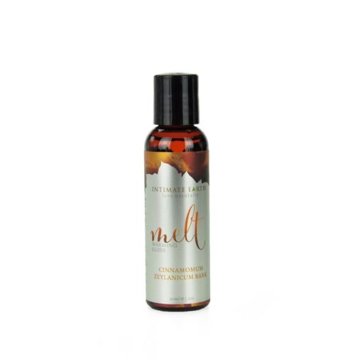 A bottle of essential oil with a mountain in the background.