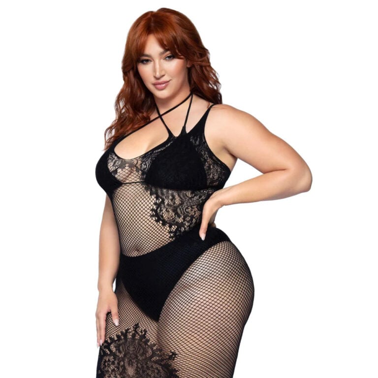 An SEO-friendly ALT tag for this image could be: "Plus-size woman in black lace and fishnet lingerie, showcasing sexy and confident bedroom wear for women".
