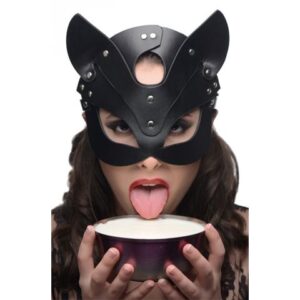 A woman in a black cat mask eating a bowl of milk.