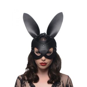 A woman wearing a black bunny mask.