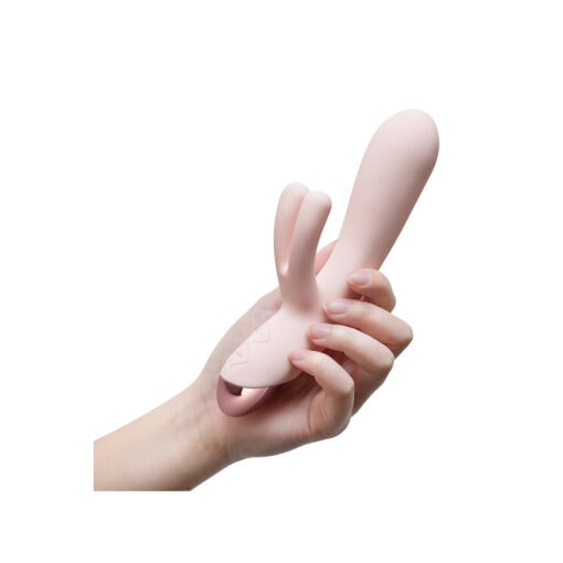 A hand holding a pink rabbit toy.