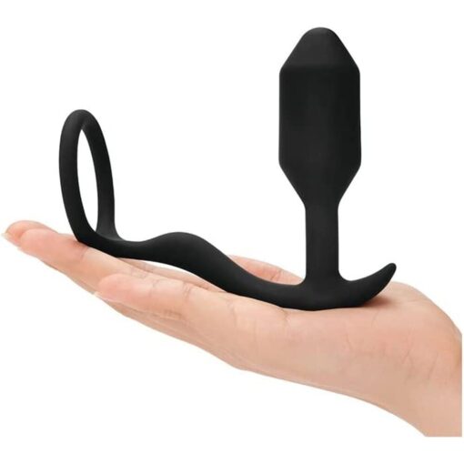 A woman's hand holding a black sex toy.
