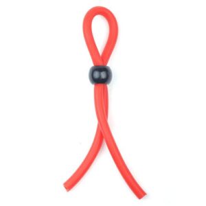 A red and black rubber sex toy on a white background.