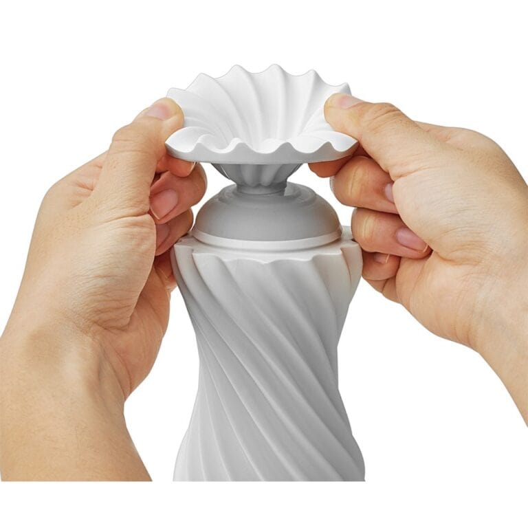 SEO-friendly ALT tag: Close-up of a white ceramic vase with a twisted, spiral design, held by hands, ideal for modern home decor and interior styling.