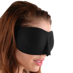 A woman wearing a black eye mask.