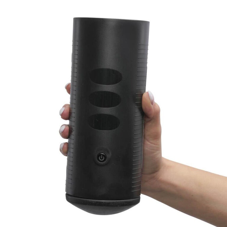 13 sex tech games that work for solo players, couples and groups Hand holding a black vibrating male masturbator device with multiple openings, designed for adult pleasure and sexual wellness, featuring discreet and ergonomic design.