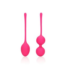 Two pink plastic spoons on a white surface.