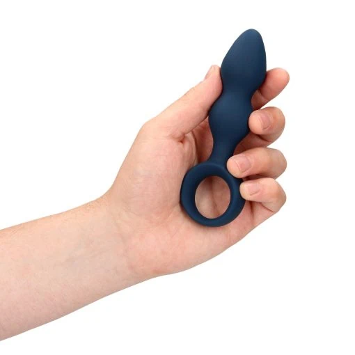 A hand holding a blue vibrating toy.