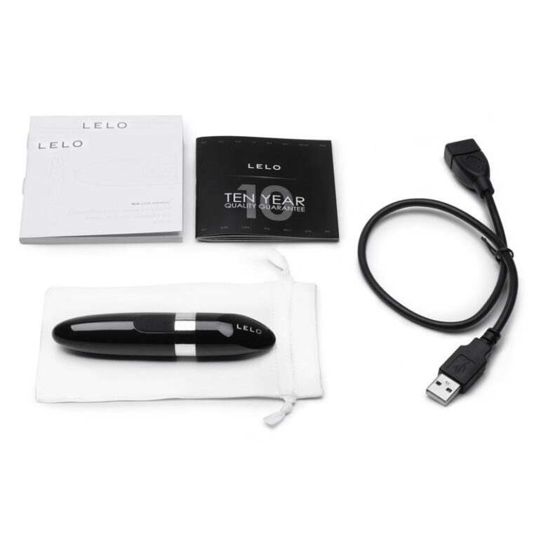 An elegant LELO vibrator with USB charging cable, user manuals, and warranty card, designed for intimate pleasure and high-quality adult toys.