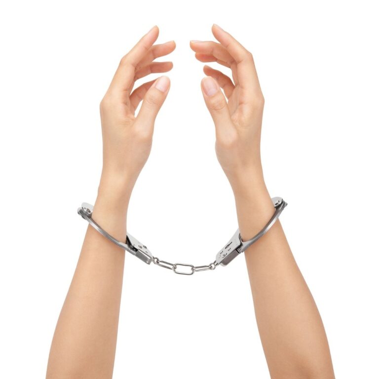 An image of hands in handcuffs symbolising the intersection of technology and intimacy, highlighting the role of sextech products in enhancing sexual experiences and personal wellness.