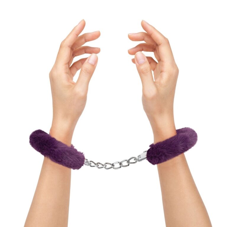 Restraint-themed image featuring hands in purple fur cuffs connected by a chain, highlighting adult intimacy, BDSM accessories, and sexual wellness products for an engaging and relevant visual for SEX.