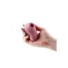 A hand holding a pink sex toy.