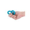 A hand holding a pair of blue rubber rings.