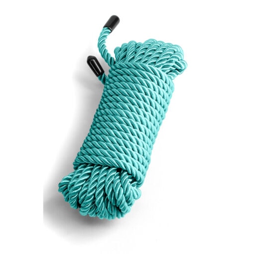 A roll of turquoise rope on a white background.