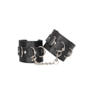 A pair of black leather cuffs with chains.