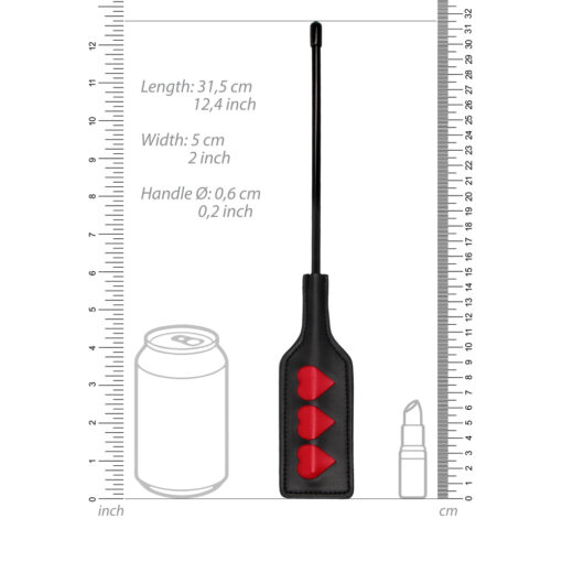 A measuring tool with a can and a bottle next to it.