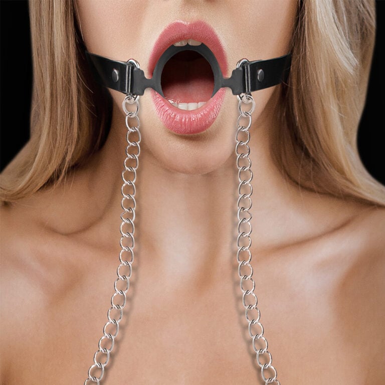 A close-up of a woman wearing a black leather mouth gag with metal chains, highlighting BDSM restraint gear for adult pleasure and kink exploration.