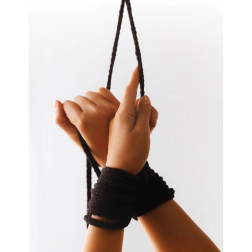A woman's hand holding a black rope.