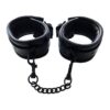 A pair of black leather cuffs on a white background.