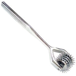 A stainless steel spatula with spikes on it.
