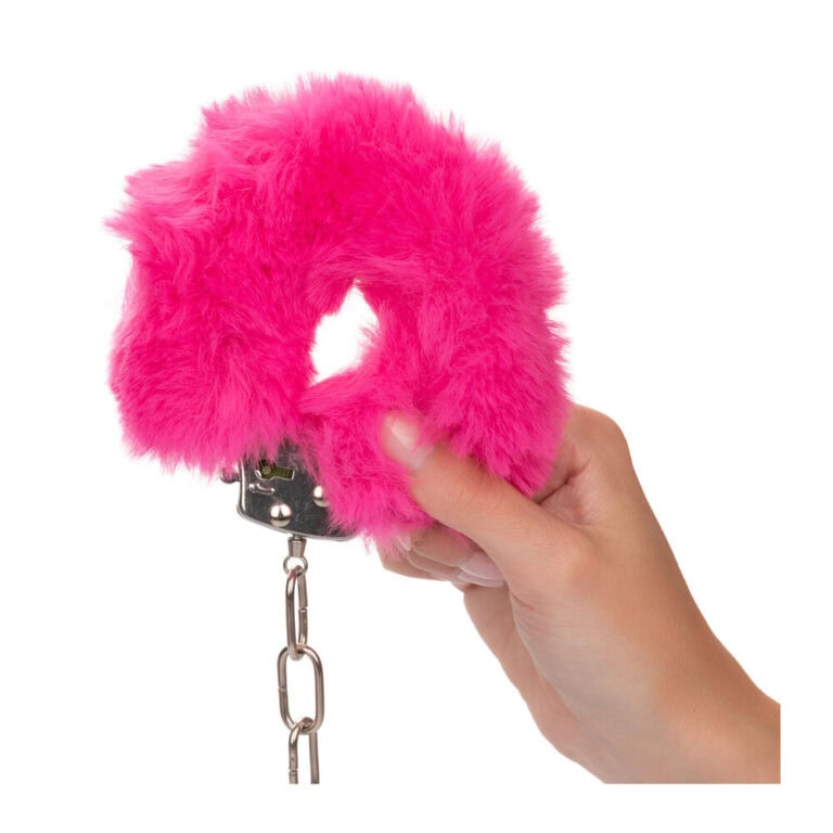 Bright pink fluffy handcuffs for adult intimacy and role-play scenarios, combining fun and sensuality. Perfect for enhancing intimacy and exploring fantasies with a soft, plush texture.