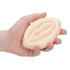A person is holding a soap in their hand.