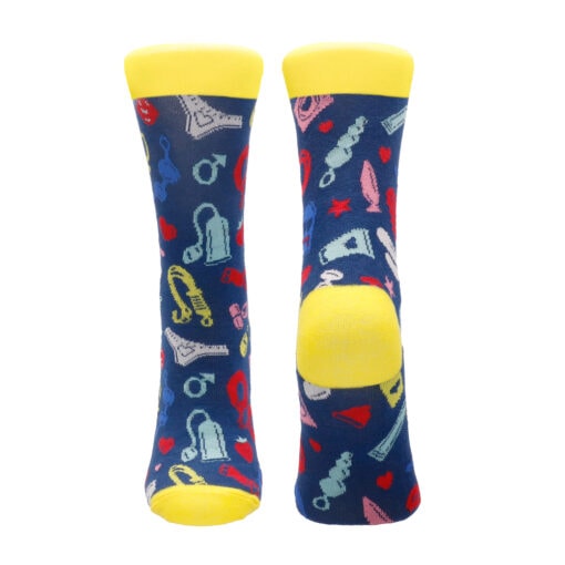 A pair of blue and yellow socks with musical instruments on them.