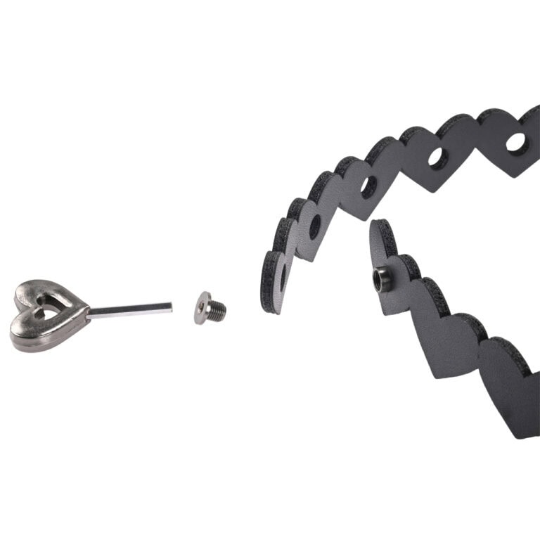 Close-up of a modern sextech device with interconnected black foam elements and metallic components, designed for enhancing intimacy and pleasure, showcasing innovative adult technology.