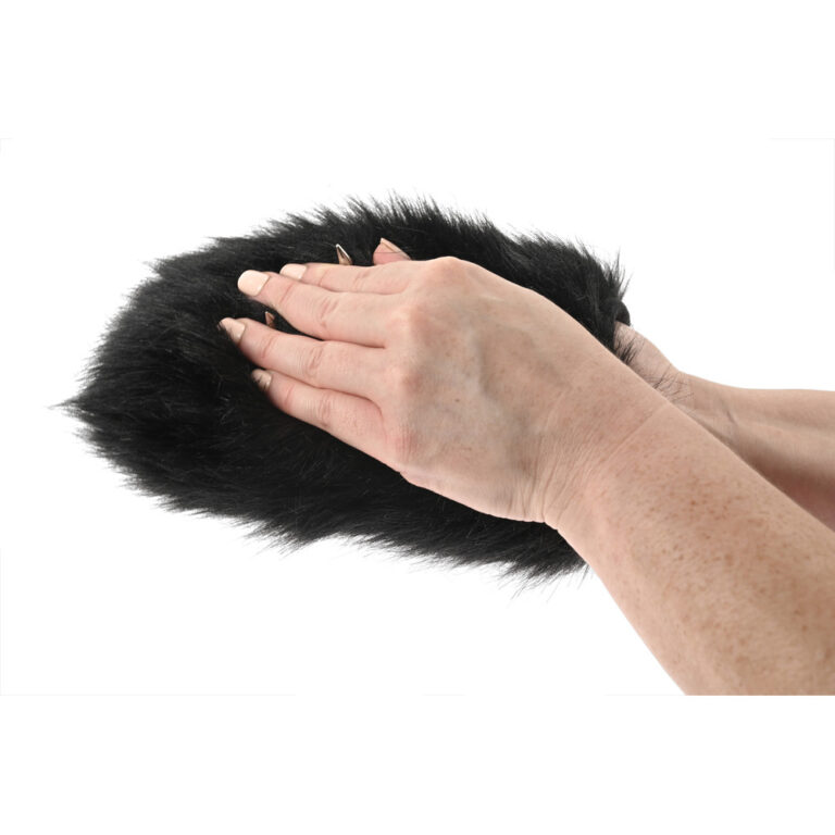 Close-up of hands using a black spiked sensory mitt