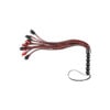 A red and black braided sex toy on a white background.