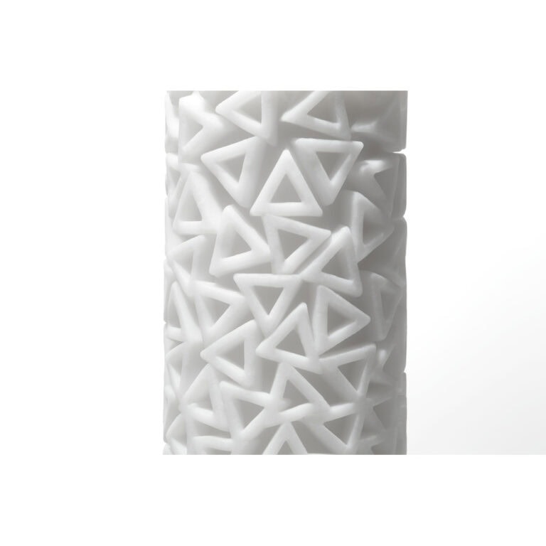 Elegant white candle featuring a contemporary geometric pattern with triangular cutouts, perfect for enhancing mood and adding a modern touch to any space.