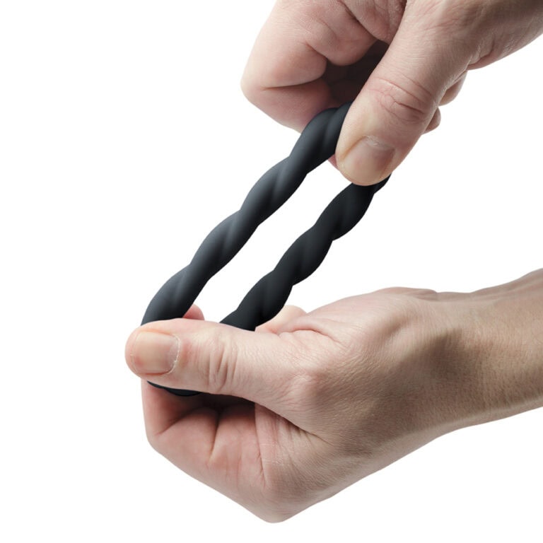 A close-up of a hand holding a black twisted silicone pleasure rope, designed for intimate restraint and sensual stimulation, ideal for enhancing sexual experiences.