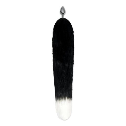 A black and white fur tail hanging on a white background.