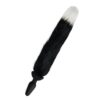 A black and white furry sex toy on a white surface.