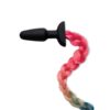 A black and pink braided hair plug with a black handle.