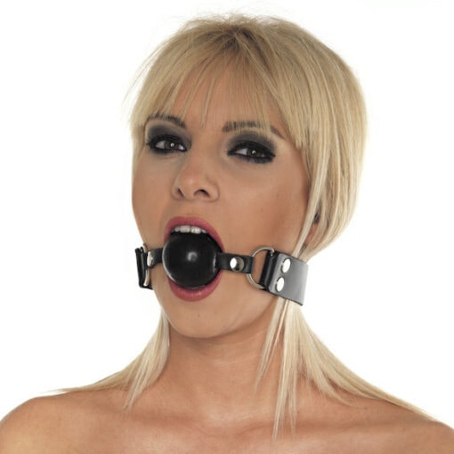 A woman wearing a black gag with a ball in her mouth.