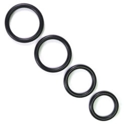 Four black rubber o-rings on a white background.