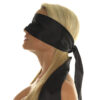 A blond woman wearing a black blindfold.